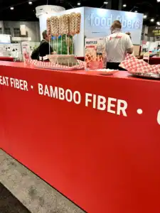 Red Bamboo Fiber Food counter with people standing behind it.