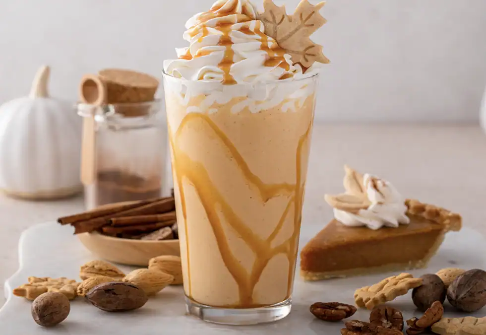Glass of Pumpkin spice latte with whipped cream on top