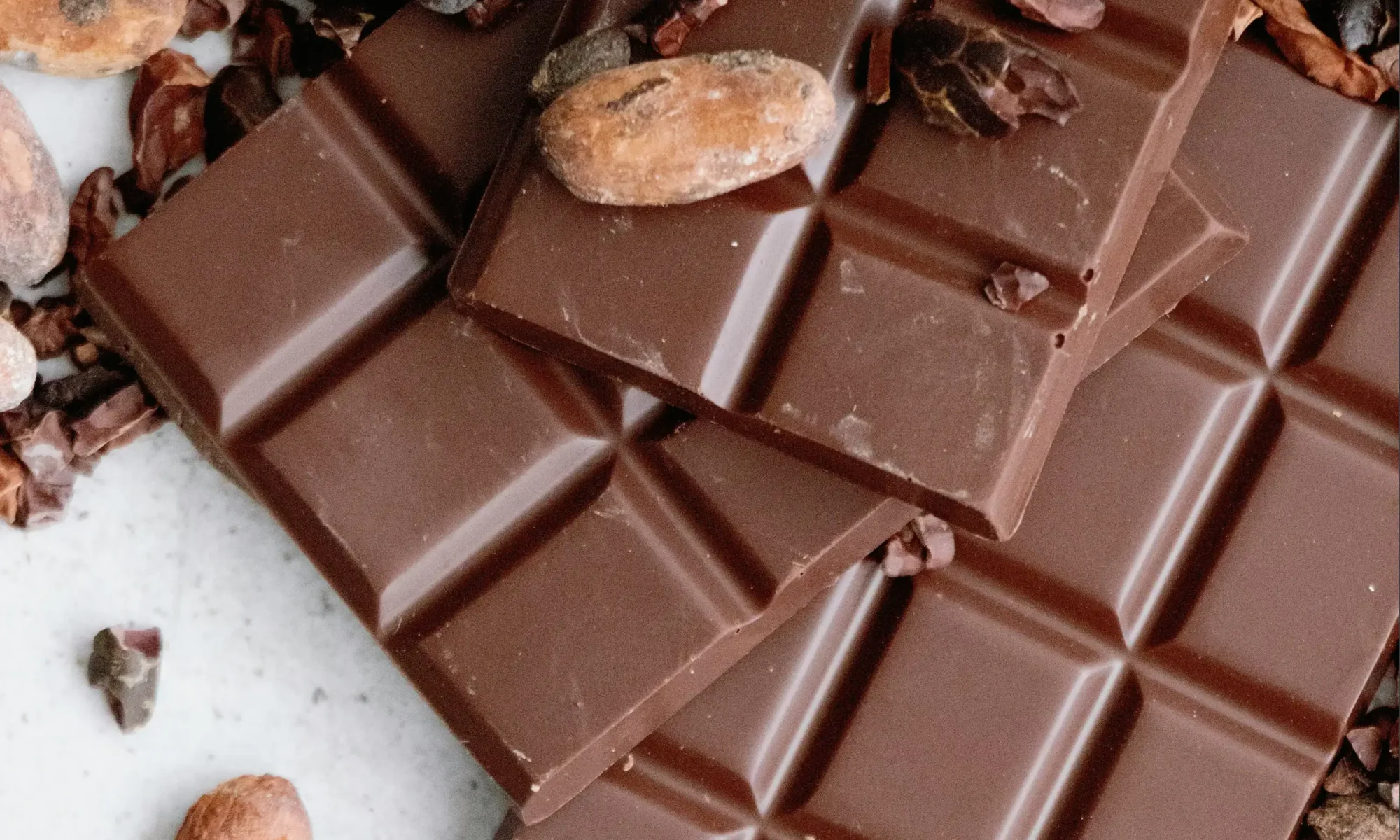Cocoa beans on top of chocolate bars.