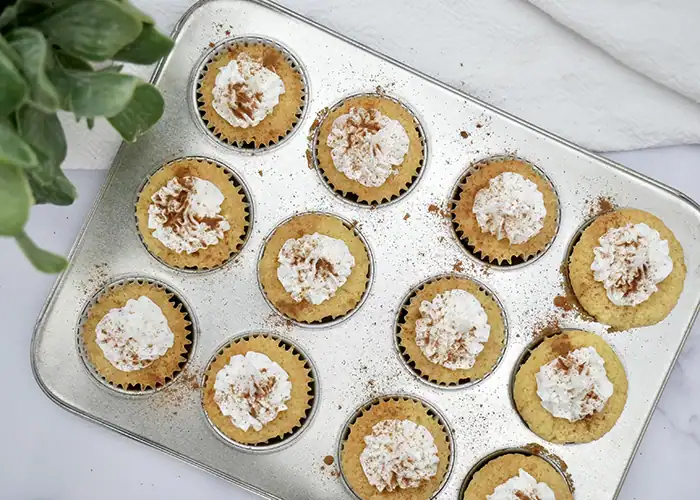 Jogue Chai cupcakes in a cupcake pan with spice garnish on the whipped cream topping