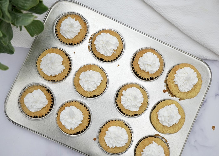 Jogue Chai cupcakes in a cupcake pan with whipped cream topping